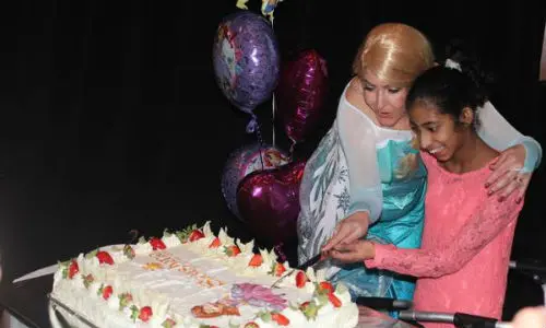 Nethulya, a 12-year-old from Newmarket, will have her dreams come true thanks to the Sunshine Foundation and OARA members. She is shown here cutting a cake at the official launch announcement of the 2017 Tire Take Back event, with assistance from Princess Elsa. 